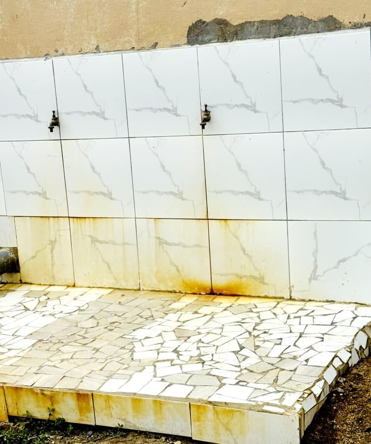 The tiled drinking water point with taps in the school yard